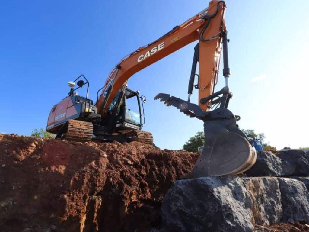 Mountainside Land Services building a boulder wall for backyard.