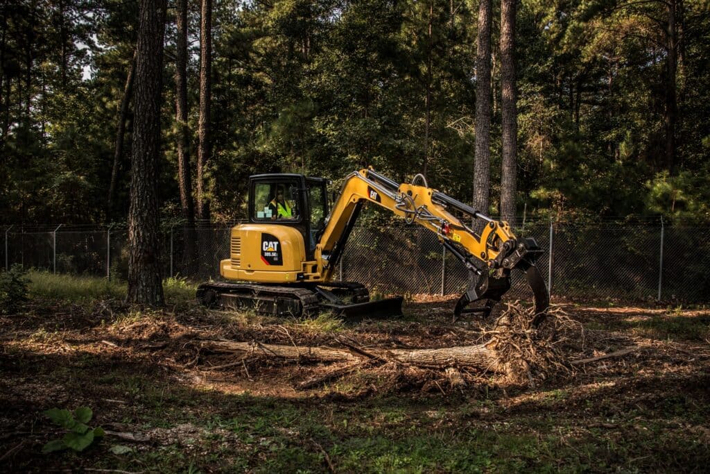 A Cat 305.5E2 excavator clearing trees